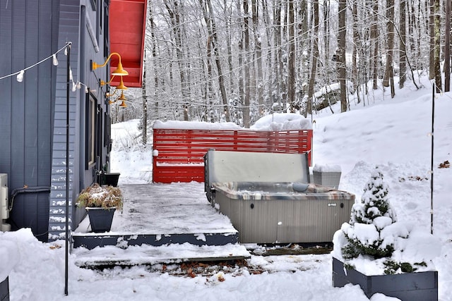 snow covered patio with a hot tub