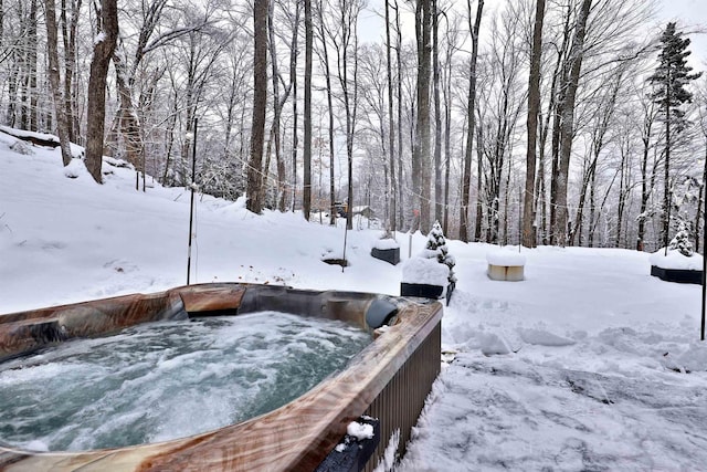 yard layered in snow featuring a hot tub