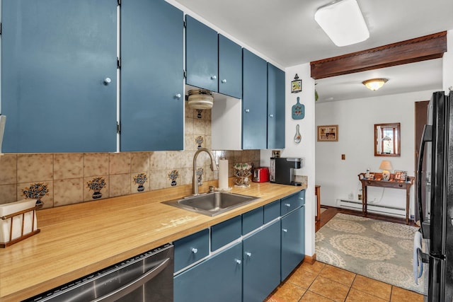 kitchen featuring black fridge, blue cabinets, sink, and a baseboard heating unit