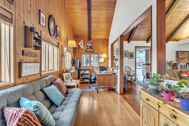 office with vaulted ceiling with beams, wooden walls, light hardwood / wood-style flooring, and wooden ceiling