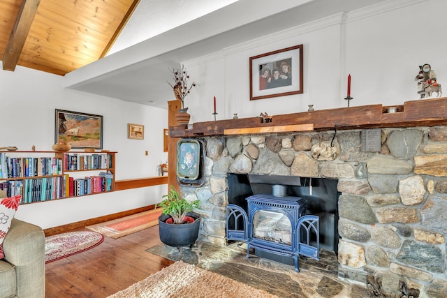 room details featuring beamed ceiling, hardwood / wood-style floors, a wood stove, and wood ceiling