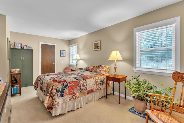 bedroom featuring light carpet