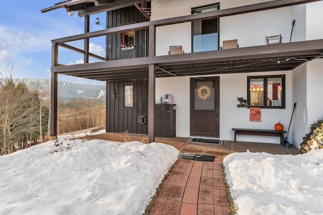 snow covered property entrance with a mountain view