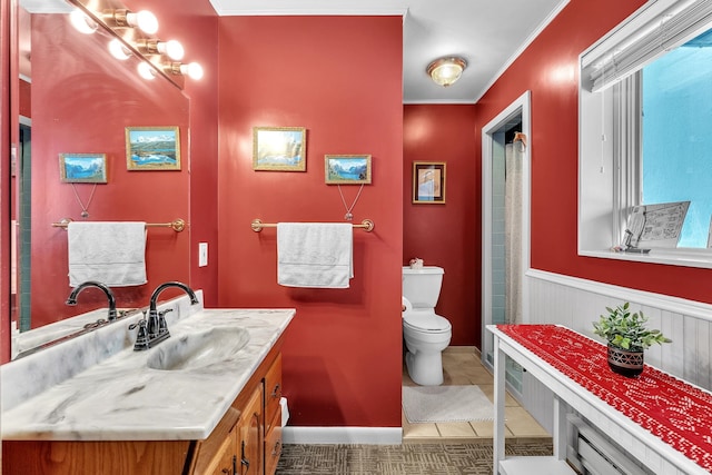 bathroom featuring tile patterned floors, vanity, toilet, and crown molding