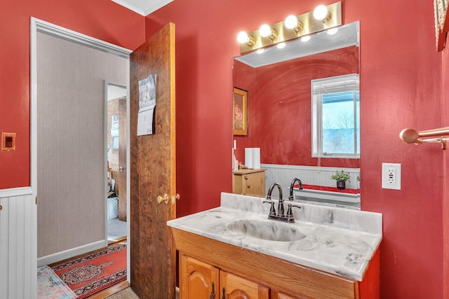 bathroom with crown molding and vanity