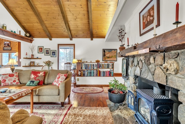 living room with hardwood / wood-style flooring, lofted ceiling with beams, wooden ceiling, and a wood stove