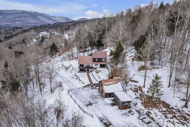 snowy aerial view with a mountain view