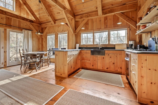 kitchen with sink, wooden ceiling, light brown cabinets, beamed ceiling, and light hardwood / wood-style floors