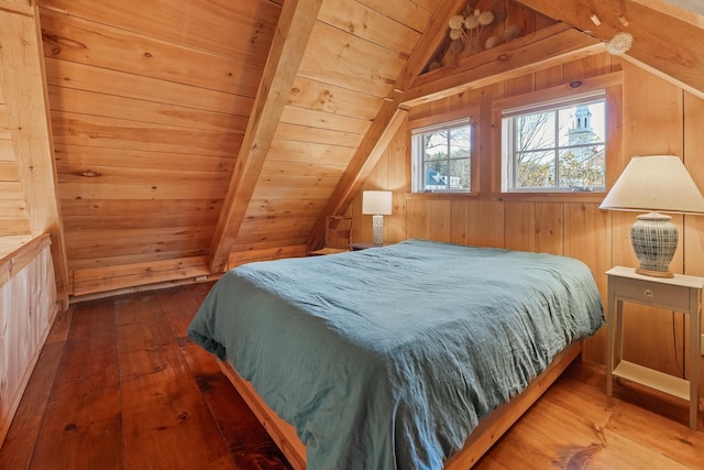 bedroom with wood ceiling, wooden walls, hardwood / wood-style floors, and vaulted ceiling with beams