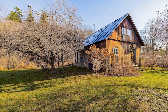 view of side of home with a lawn