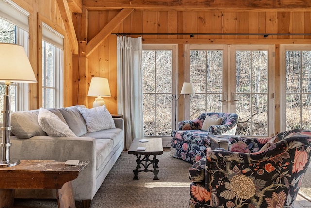 living room featuring wooden walls and carpet flooring