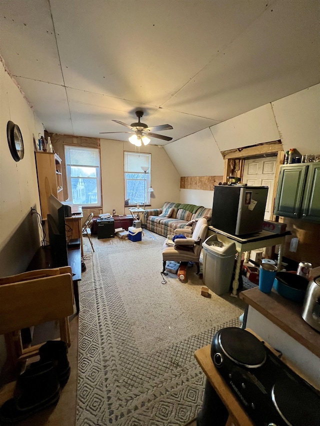 carpeted living room with vaulted ceiling and ceiling fan