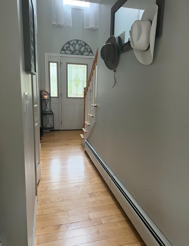 entryway featuring baseboard heating and light hardwood / wood-style floors