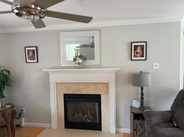 living room featuring ornamental molding, ceiling fan, light hardwood / wood-style floors, and baseboard heating