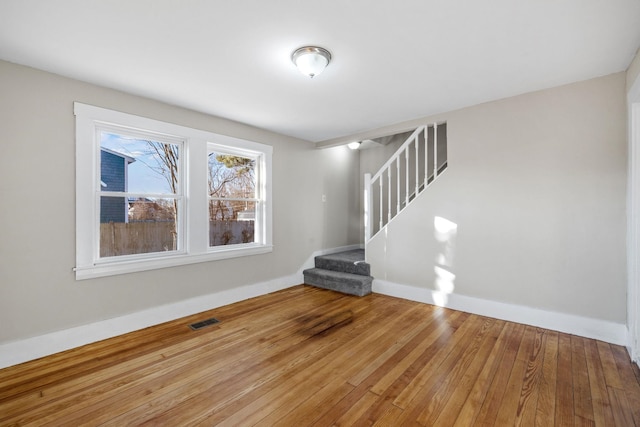 unfurnished living room featuring wood-type flooring