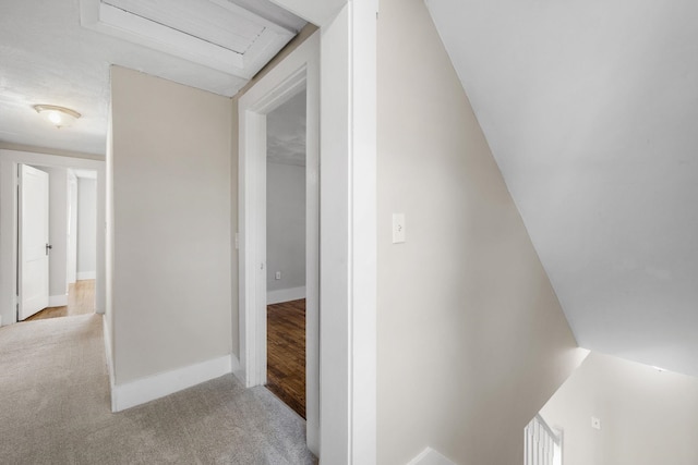 hall with light colored carpet and lofted ceiling