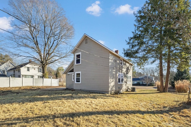 view of home's exterior with a lawn and central air condition unit