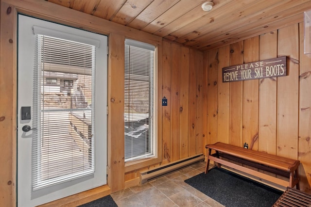 doorway to outside featuring wood ceiling, wooden walls, and a baseboard heating unit