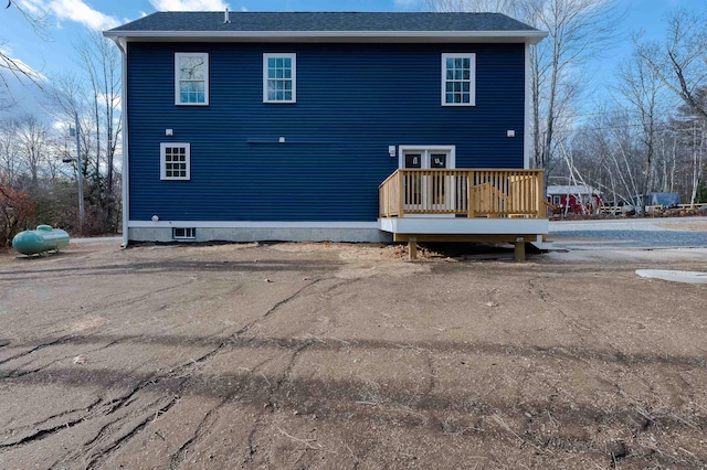 back of property featuring a wooden deck