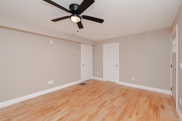 spare room featuring light wood-type flooring and ceiling fan