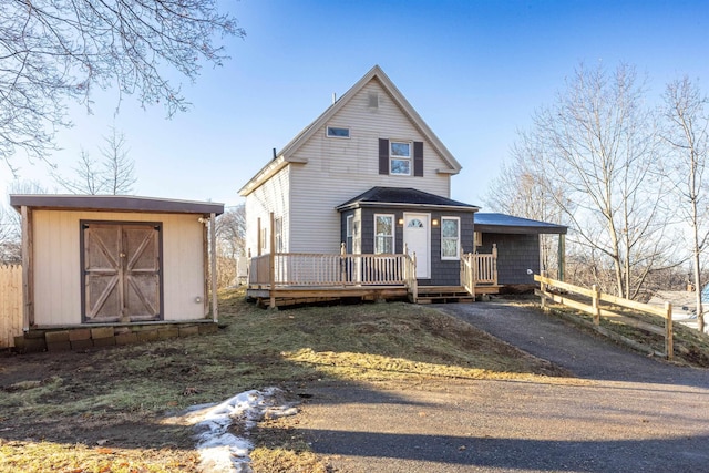 view of front of home featuring a storage shed