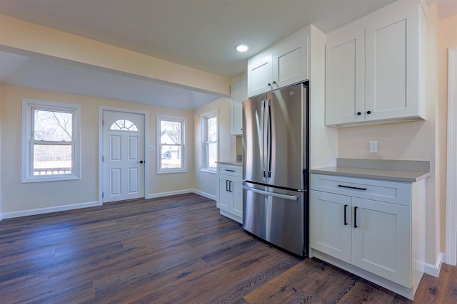 kitchen featuring stainless steel refrigerator, white cabinetry, a healthy amount of sunlight, and dark hardwood / wood-style floors