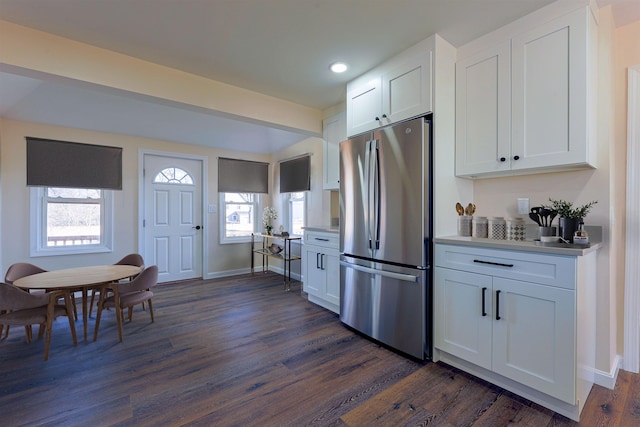 kitchen with stainless steel refrigerator, white cabinetry, and dark hardwood / wood-style flooring