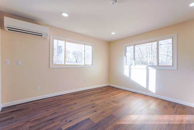 unfurnished room with dark hardwood / wood-style floors and an AC wall unit