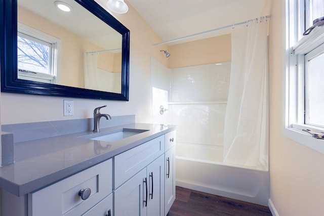 bathroom featuring vanity, wood-type flooring, and shower / bathtub combination with curtain