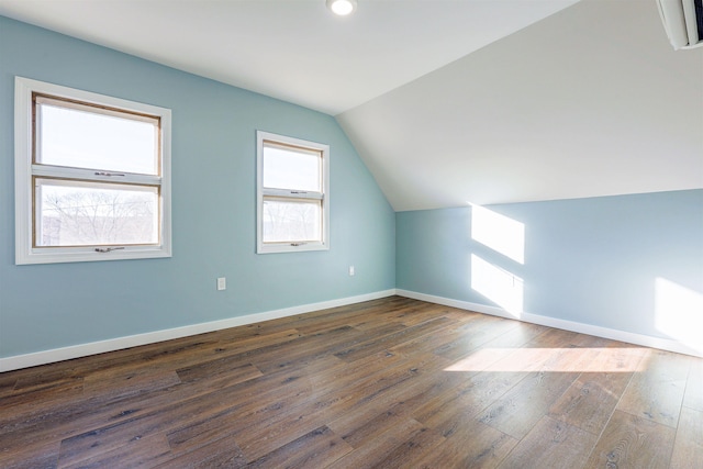 bonus room with dark hardwood / wood-style floors and lofted ceiling