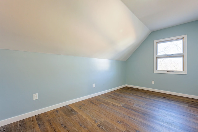 additional living space featuring hardwood / wood-style floors and lofted ceiling