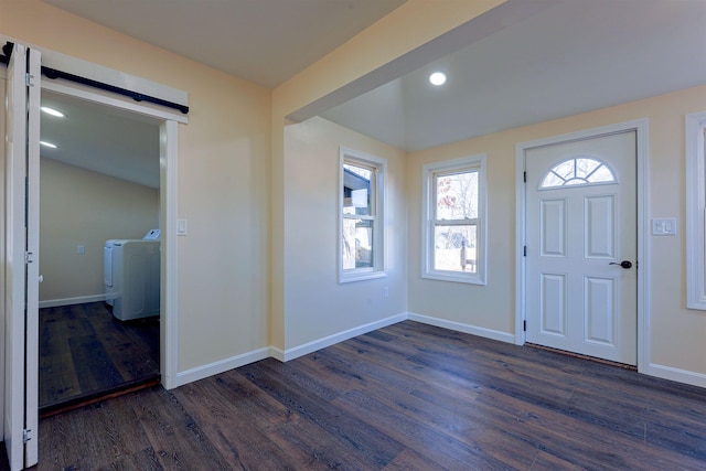 entrance foyer featuring dark hardwood / wood-style flooring, separate washer and dryer, and a barn door