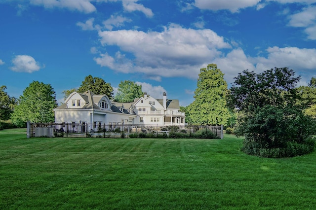 back of house with a lawn