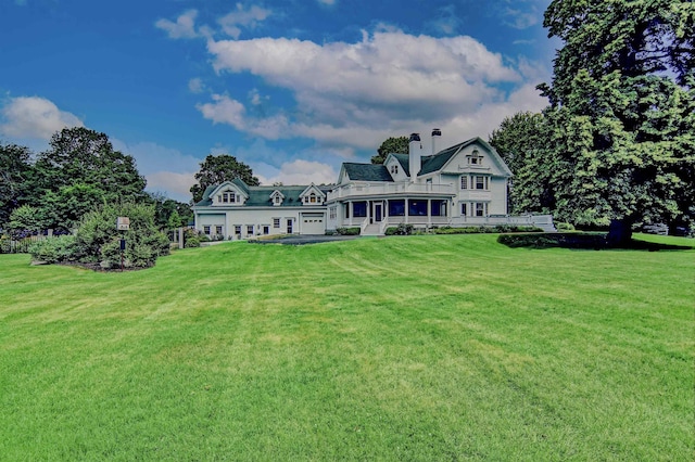 back of house featuring a yard and a sunroom