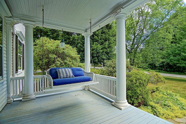 wooden terrace featuring covered porch