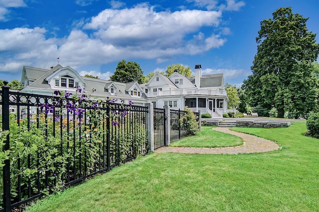 back of property featuring a sunroom and a yard