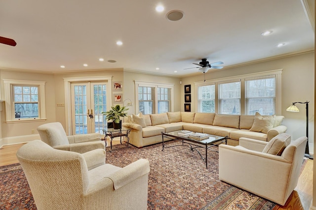 living room with ceiling fan, french doors, crown molding, and plenty of natural light