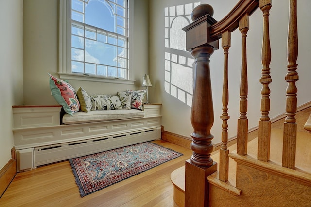 sitting room with a baseboard radiator and light hardwood / wood-style floors