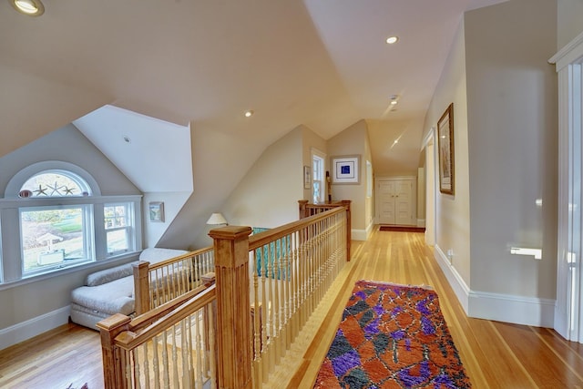 hall featuring light hardwood / wood-style floors and lofted ceiling