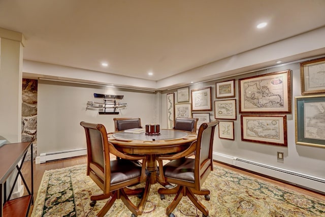 dining area featuring hardwood / wood-style flooring and baseboard heating