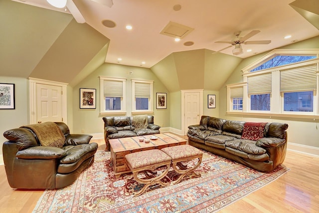 living room featuring ceiling fan, light wood-type flooring, and vaulted ceiling