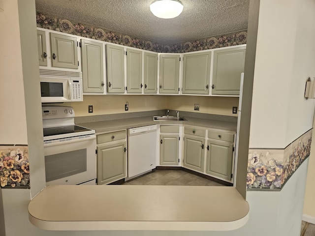 kitchen featuring a textured ceiling, sink, and white appliances