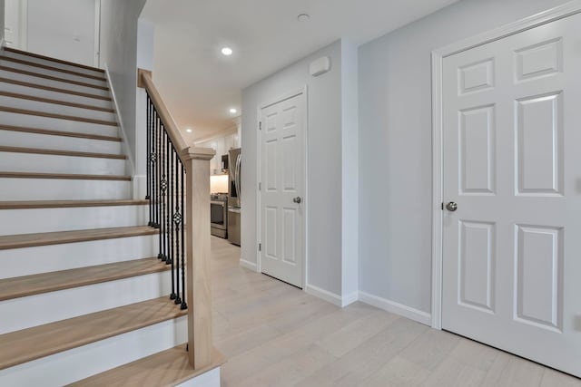 stairs with hardwood / wood-style flooring