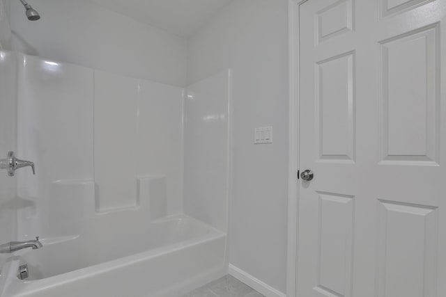 bathroom featuring tile patterned flooring and washtub / shower combination