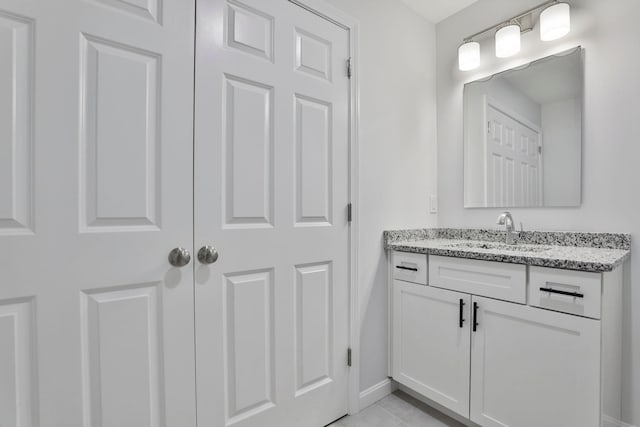 bathroom featuring tile patterned flooring and vanity