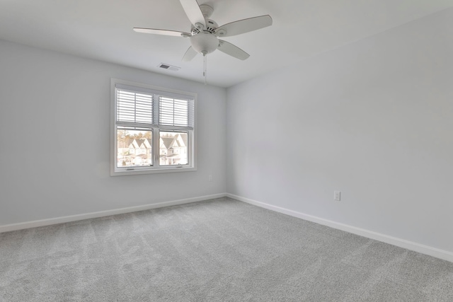 carpeted spare room with ceiling fan