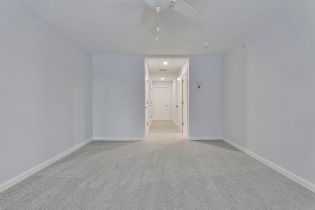 carpeted spare room featuring ceiling fan