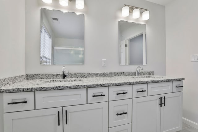 bathroom featuring vanity and a shower with door