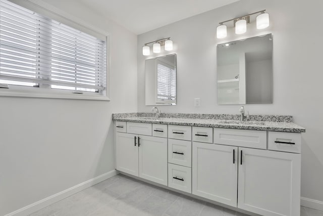 bathroom with tile patterned floors and vanity