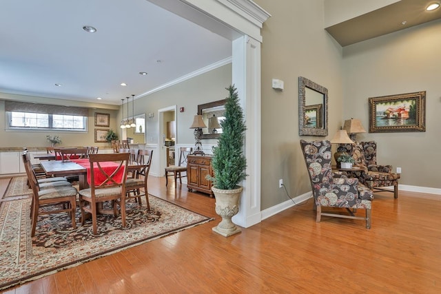 dining room featuring a chandelier, crown molding, and light hardwood / wood-style flooring